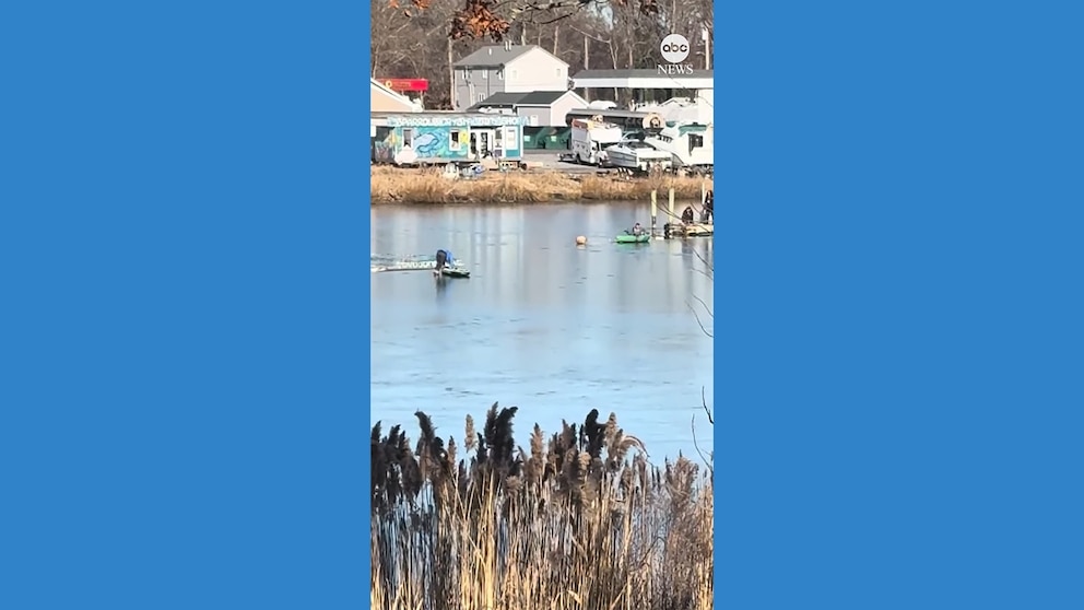 WATCH: Woman uses paddleboard to help rescue man who fell into creek