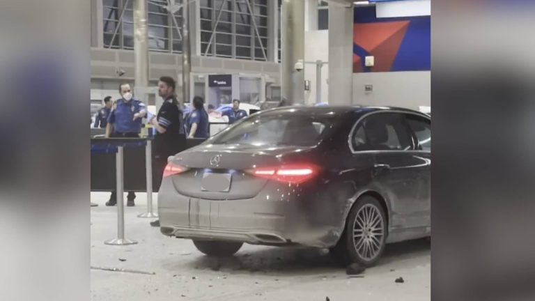 Driver in custody after car crashes into Detroit airport terminal